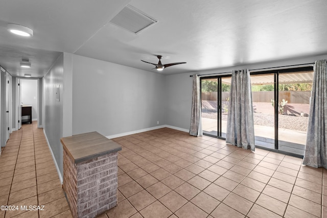 unfurnished living room featuring ceiling fan and light tile patterned floors