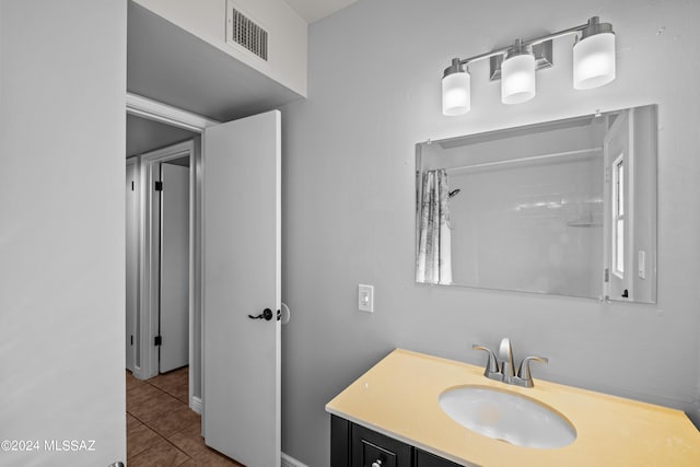 bathroom featuring walk in shower, tile patterned floors, and vanity