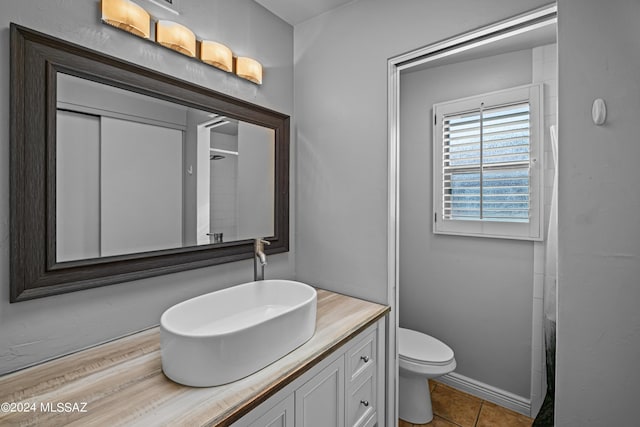 bathroom featuring vanity, toilet, tile patterned floors, and a shower with shower curtain