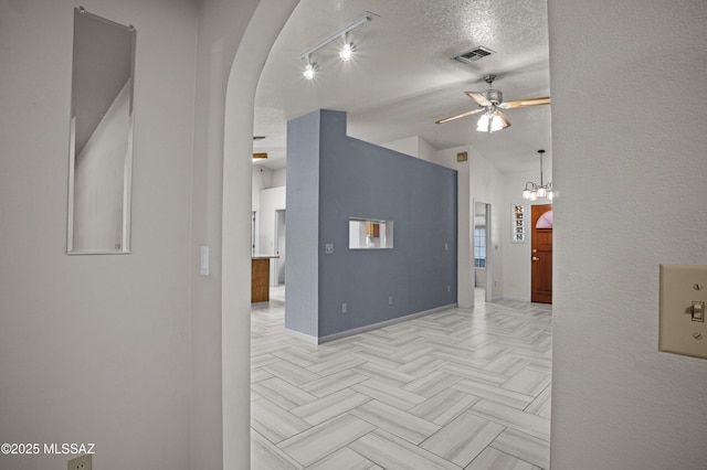3873 W Allred St, Thatcher, AZ 85552 - hall featuring baseboards, track lighting, arched walkways, and a textured ceiling