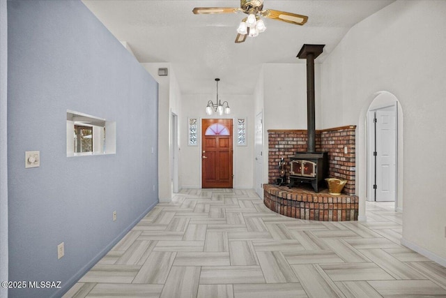 3873 W Allred St, Thatcher, AZ 85552 - foyer entrance featuring a wood stove, baseboards, a ceiling fan, and a chandelier