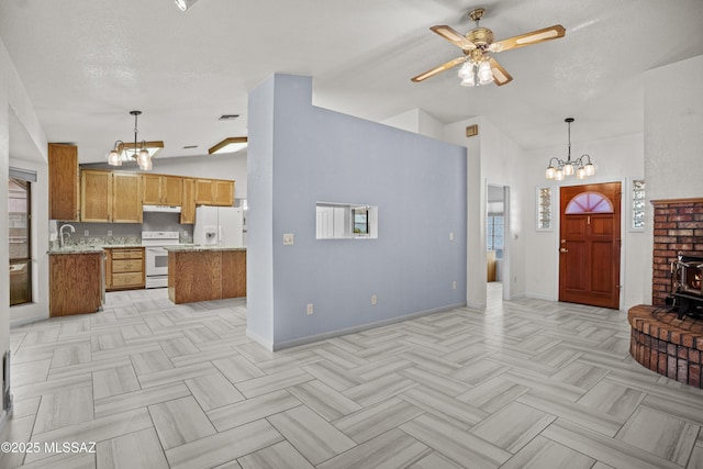 3873 W Allred St, Thatcher, AZ 85552 - kitchen featuring a chandelier, white appliances, lofted ceiling, ceiling fan, and brown cabinets
