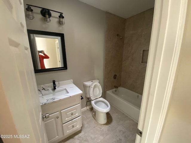 full bathroom with toilet, tiled shower / bath, and vanity