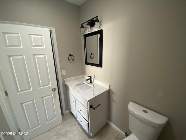 bathroom featuring toilet and vanity