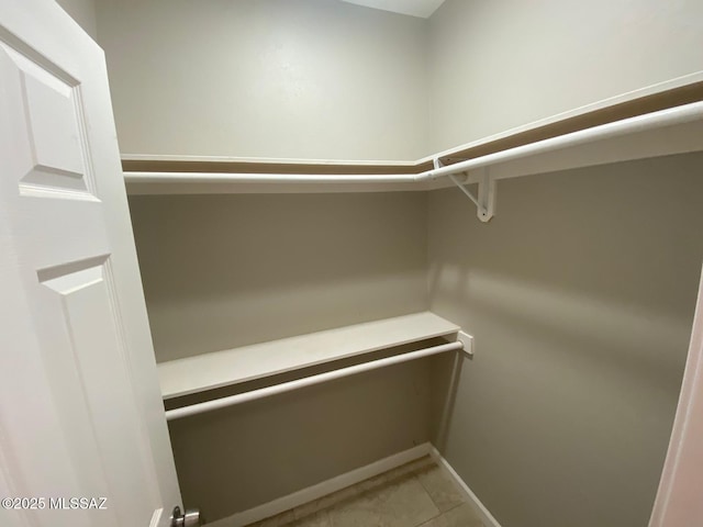 spacious closet featuring light tile patterned floors