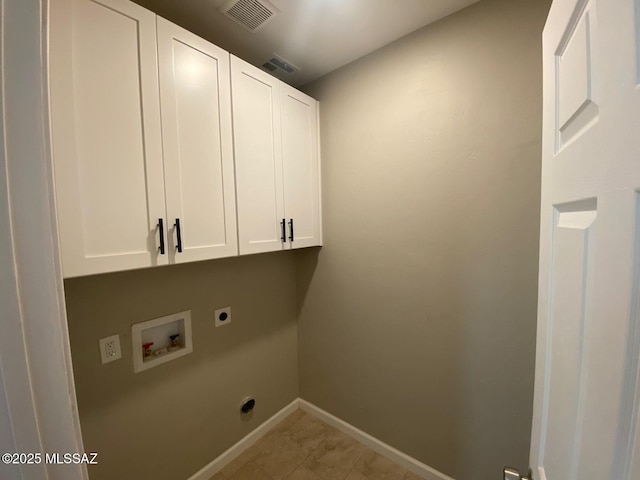 laundry area with washer hookup, hookup for an electric dryer, light tile patterned floors, and cabinets