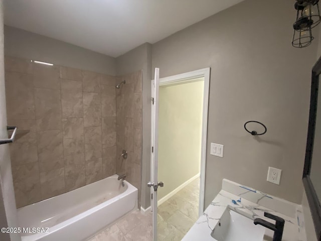 bathroom with tiled shower / bath combo and sink