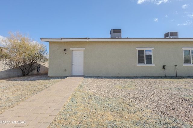 back of property featuring central AC