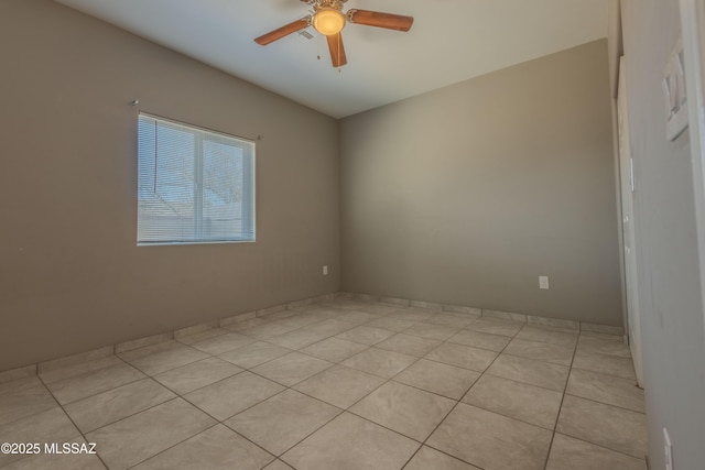 spare room featuring light tile patterned floors and ceiling fan