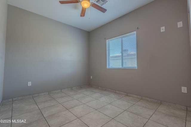 empty room featuring light tile patterned floors and ceiling fan