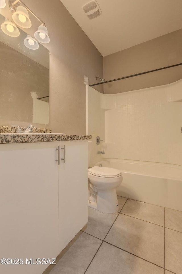 full bathroom featuring vanity, toilet,  shower combination, and tile patterned flooring