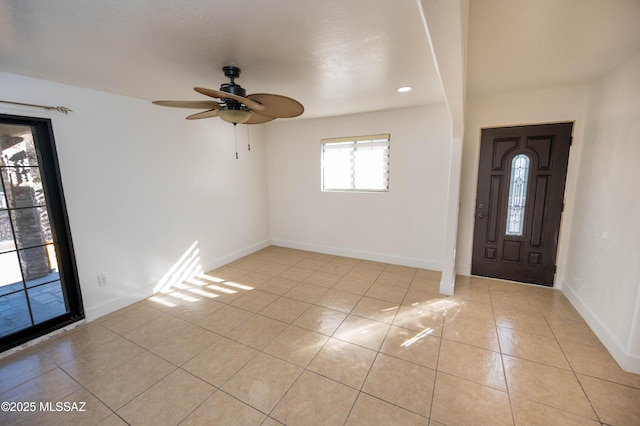 tiled foyer entrance featuring ceiling fan