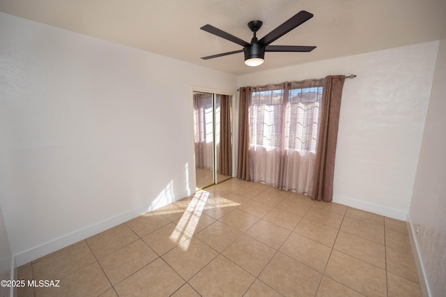 unfurnished room featuring ceiling fan and light tile patterned floors