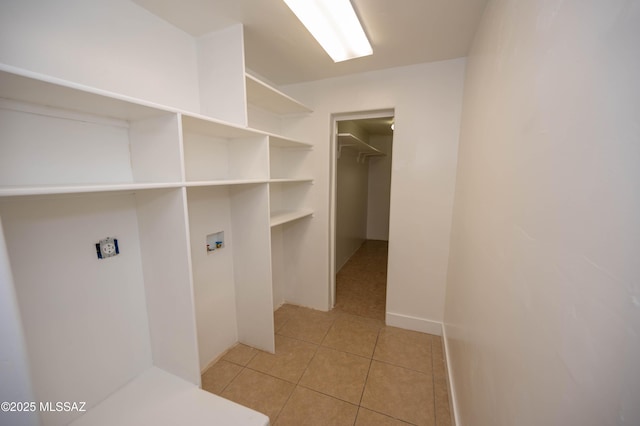 clothes washing area featuring washer hookup and light tile patterned floors