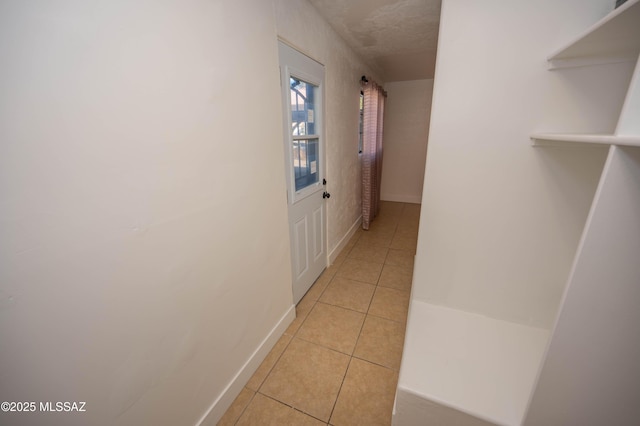 corridor featuring light tile patterned floors