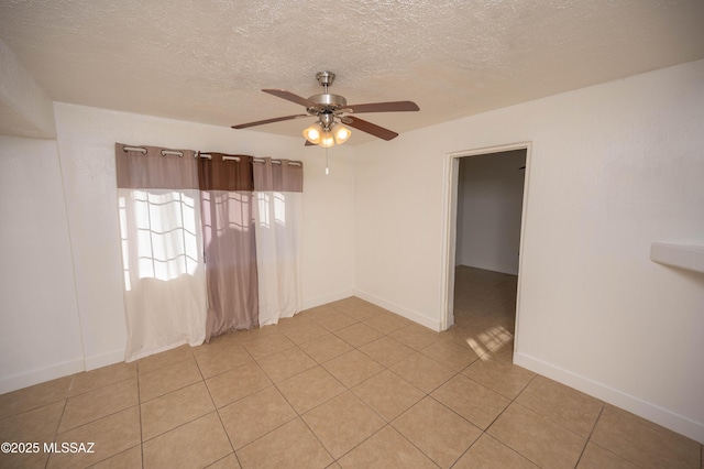 tiled spare room with ceiling fan and a textured ceiling