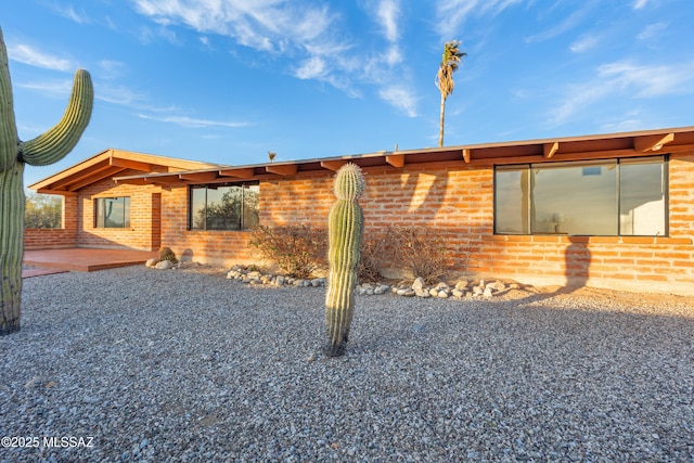 exterior space with brick siding