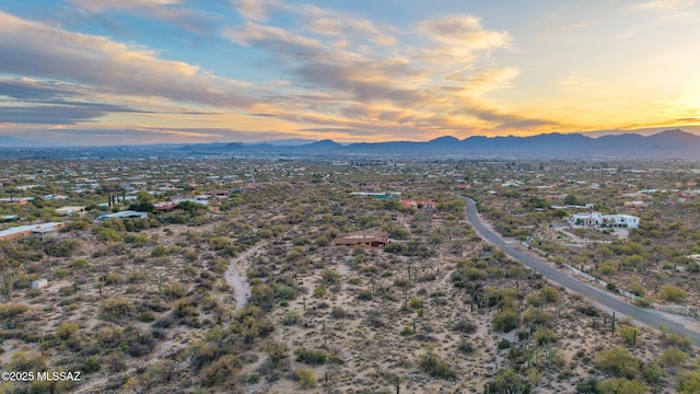 aerial view at dusk featuring a mountain view