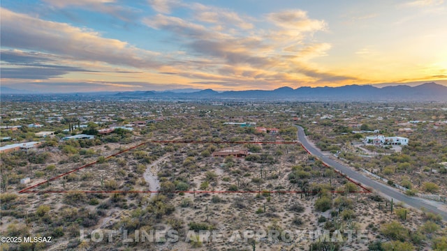 aerial view at dusk featuring a mountain view