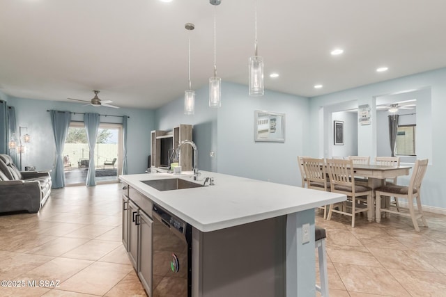 kitchen featuring sink, a center island with sink, dishwasher, pendant lighting, and ceiling fan