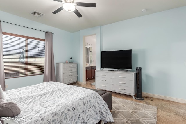 bedroom with ceiling fan and ensuite bath