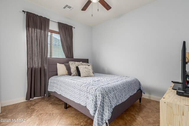 tiled bedroom featuring ceiling fan