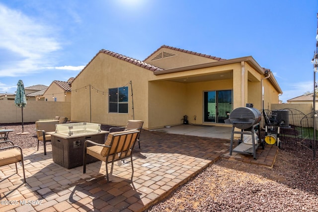 view of patio / terrace with a grill and an outdoor fire pit