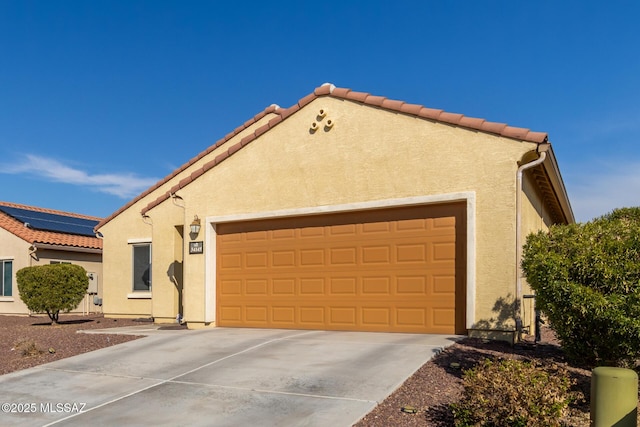 view of front of property featuring a garage and solar panels