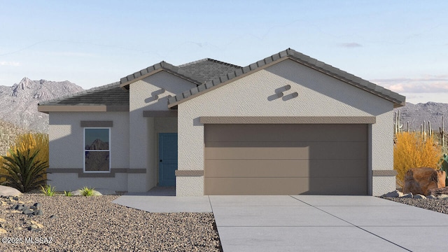 view of front of house featuring a garage and a mountain view