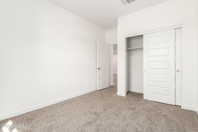 unfurnished bedroom with a closet and carpet