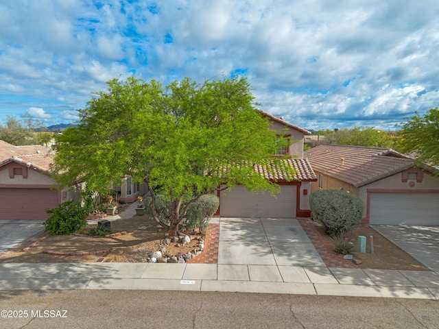 2578 W Mystic Mountain Dr, Tucson, AZ 85742 - obstructed view of property with a garage, stucco siding, concrete driveway, and a tiled roof