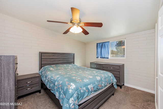 carpeted bedroom with ceiling fan, brick wall, and lofted ceiling