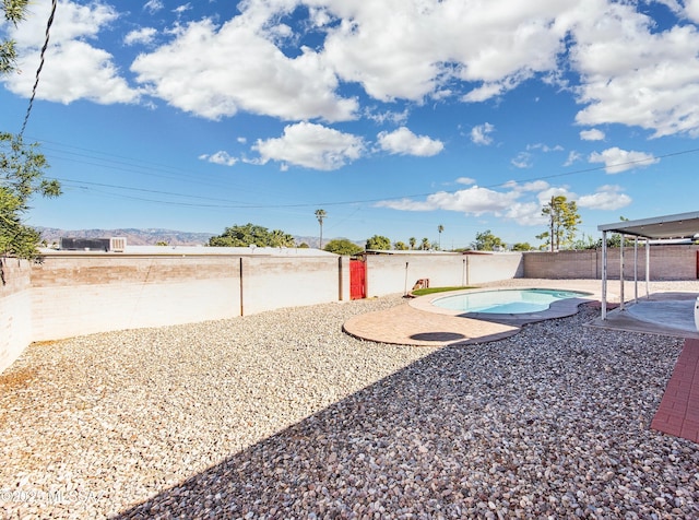 view of yard featuring a patio area and a fenced in pool