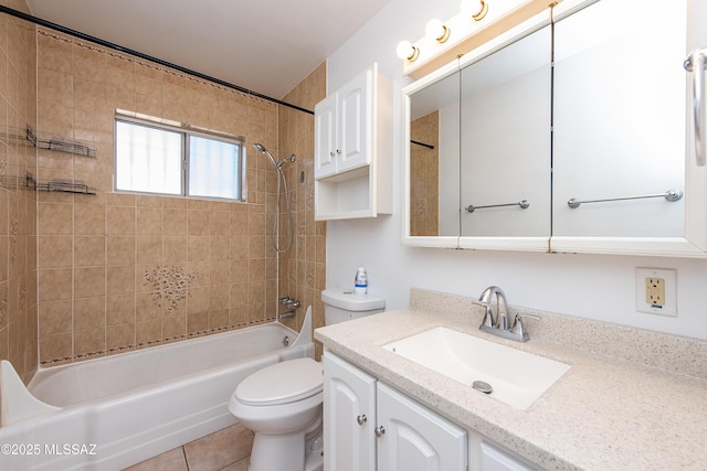 full bathroom featuring toilet, vanity, tiled shower / bath combo, and tile patterned flooring