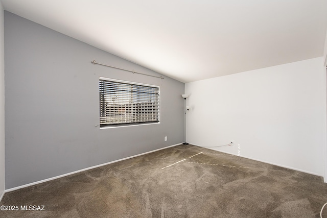 carpeted spare room with lofted ceiling