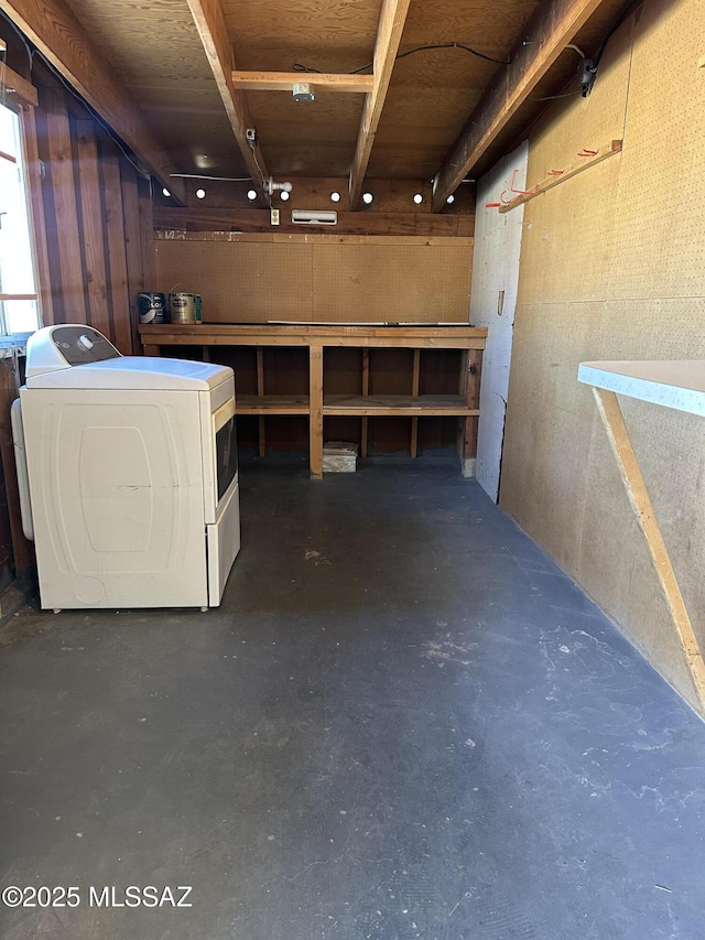 basement with a workshop area and washer / dryer