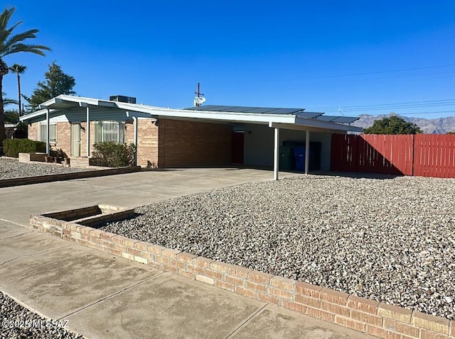 ranch-style home featuring a carport