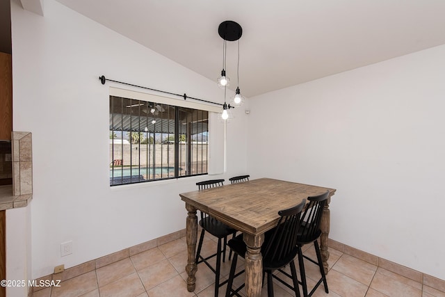 tiled dining room with lofted ceiling