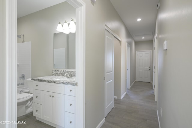 full bathroom featuring toilet, vanity, wood-type flooring, and shower / bath combination