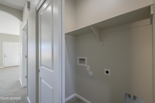 washroom with washer hookup, electric dryer hookup, and light hardwood / wood-style floors