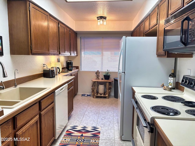 kitchen with sink and white appliances