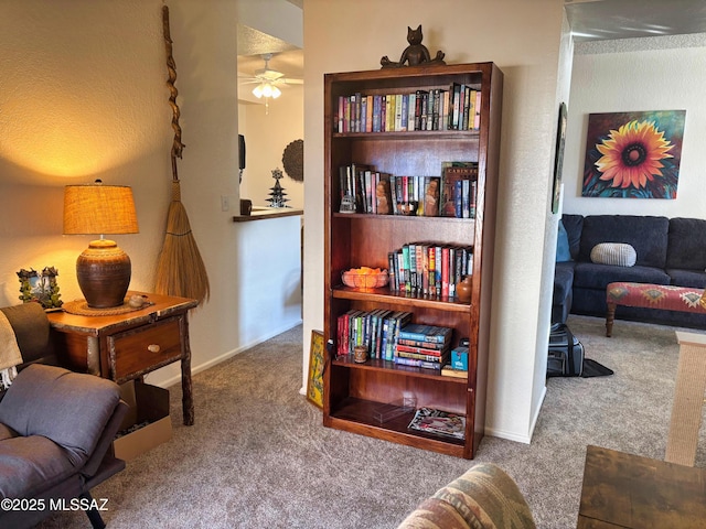 sitting room featuring ceiling fan and carpet floors