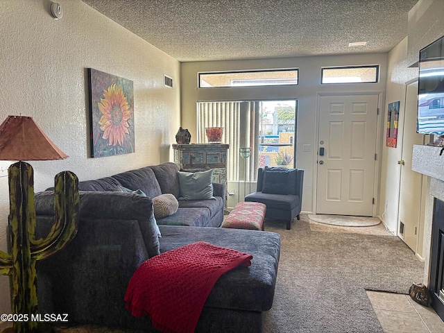 carpeted living room featuring a textured ceiling