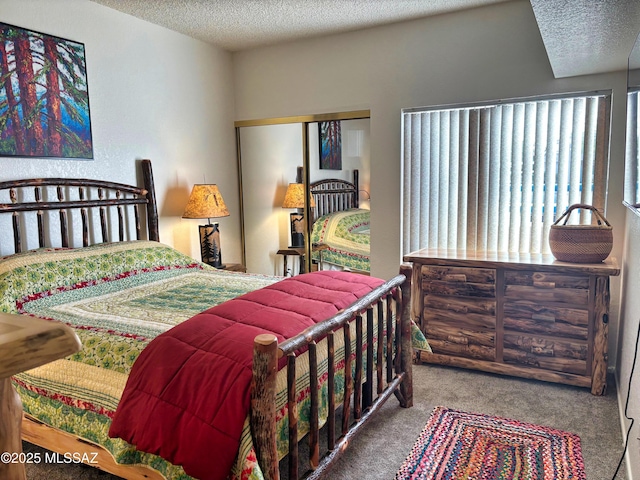 carpeted bedroom with a closet and a textured ceiling