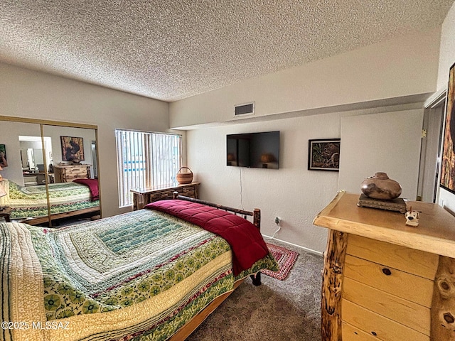 bedroom featuring a closet, carpet, and a textured ceiling