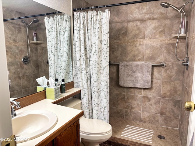 bathroom with walk in shower, vanity, and toilet