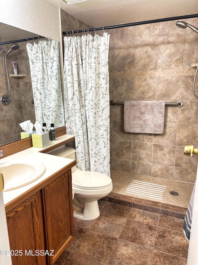 bathroom with vanity, a shower with shower curtain, a textured ceiling, and toilet