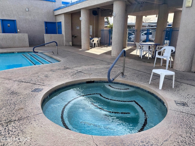 view of swimming pool with an in ground hot tub and a patio