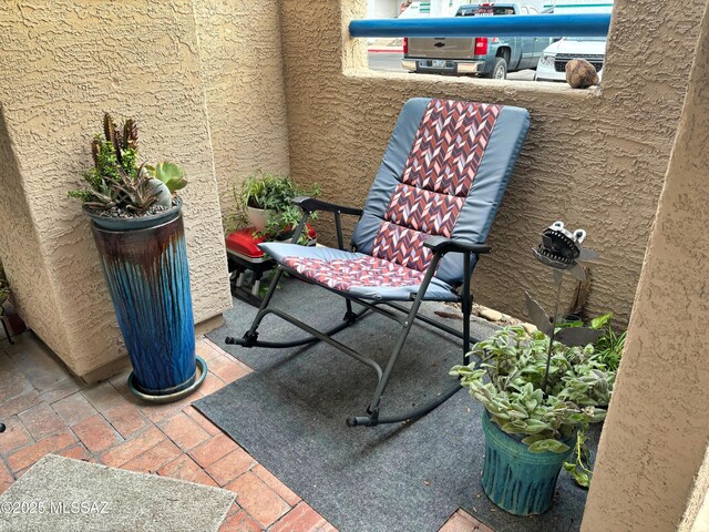 view of patio featuring a balcony