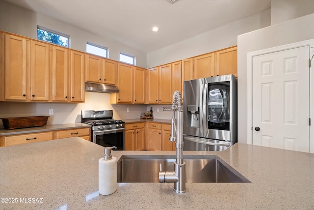 kitchen featuring light brown cabinetry, sink, light stone counters, and stainless steel appliances